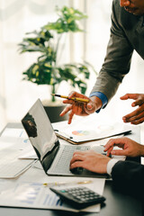 Young colleagues discussing business and price chart analyzes business people on the table great in...
