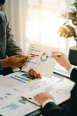 Young colleagues discuss business brainstorming and price charts analyze business people at the desk brilliantly in modern collaborative office teamwork ideas. Calculate personal tax for customers