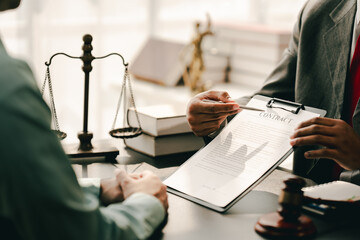 concept of justice and law A male judge in the courtroom on a wooden table and a male counselor or...