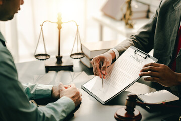 concept of justice and law A male judge in the courtroom on a wooden table and a male counselor or...