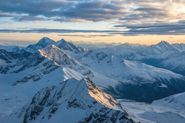 Fototapeta premium Panoramic View of Majestic Snow-Capped Mountains at Sunset in Winter