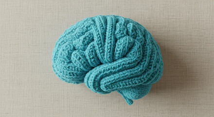 Hand-Knitted Cyan Blue Brain Sculpture on Textured Fabric | Artful Symbol of Mindfulness and Mental Health | Concept of Therapy Decor, Cognitive Wellness, Creative Healing