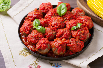 Juicy pan seared beef meatballs with tomato sauce
