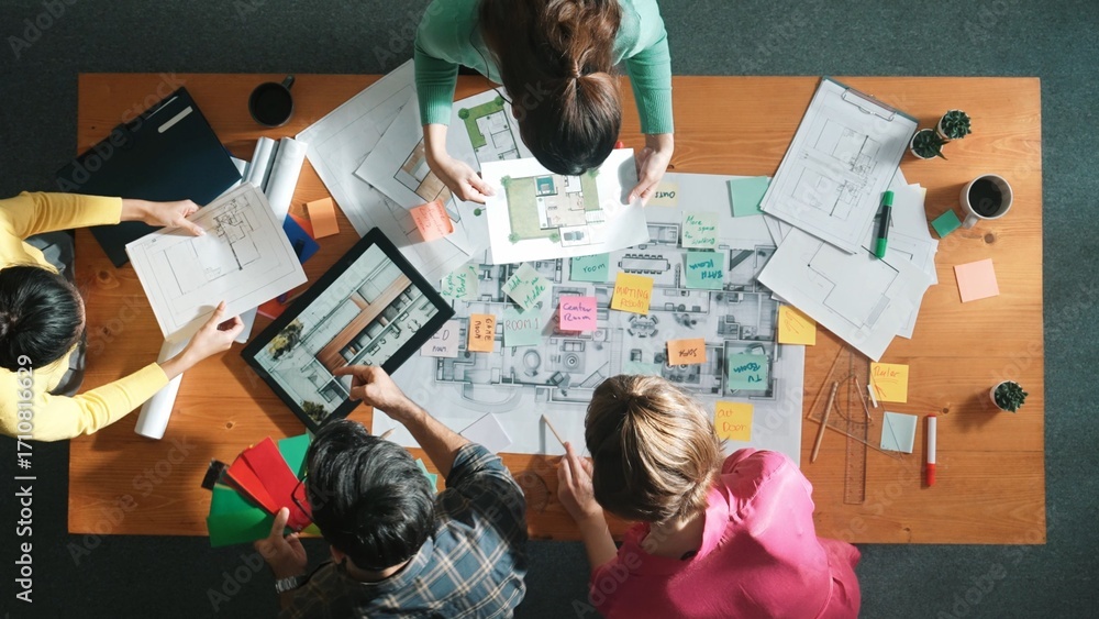 Poster top down aerial view of interior designer team choosing color from palettes while architect engineer