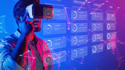 A man engages with virtual reality technology, exploring data and analytics through a vibrant, neon interface, representing a blend of innovation and productivity in a modern workspace. Raster