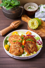 Fish patty burgers served with vegetables. Fish cakes