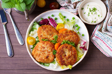 Fish patty burgers served with vegetables. Fish cakes. High angle view