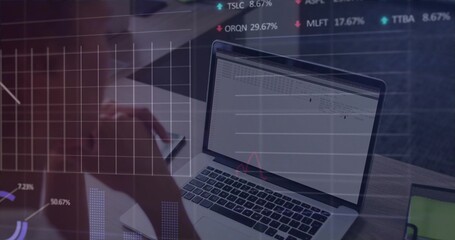 Mid-adult woman typing on silver laptop holding smartphone at desk, with floating chart overlays