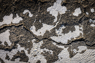 Old wall with peeling red paint and cracks as textured background