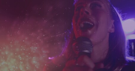 Singing performer wearing crown projecting vocals on stage, with microphone, haze, copy space