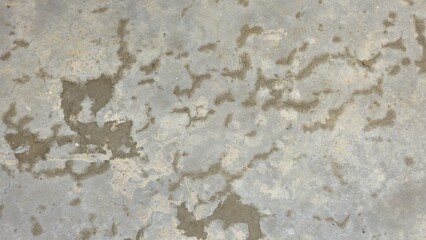 Old grey concrete floor with stains, fading, peeling paint, scratches, sidewalk, road surface, texture, and background image.