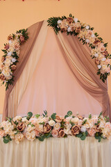 Elegant Wedding Arch and Table Decorated with Flowers.