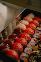 Box of assorted sushi and rolls.
