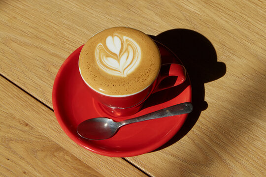 Cortado in red cup with heart foam