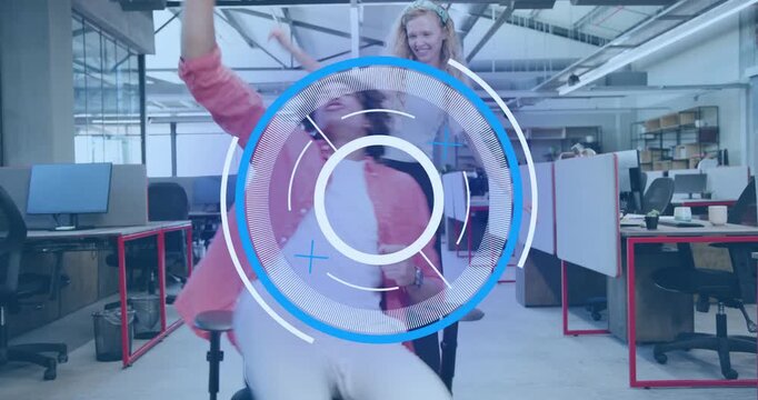 Coworker pushing swivel chair toppling colleague, collecting papers and spinning in business banter