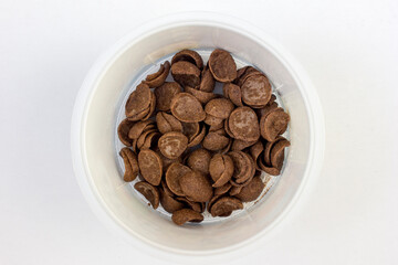 A bowl of chocolate cereal isolated on white background. Delicious nutritious Breakfast for the child
