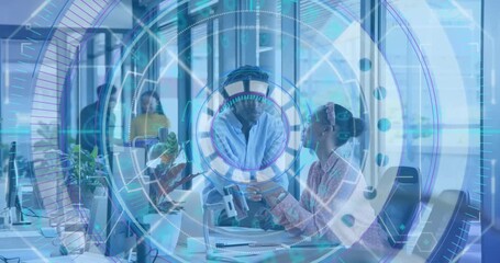 Man approaching woman showing smartphone in tech office, digital HUD pulsing as team studying data - Powered by Adobe