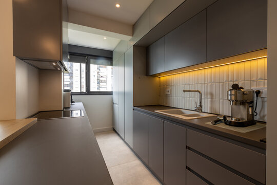 Interior of a modern minimalist kitchen featuring built-in appliances