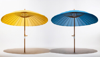 Pair Of Blue And Yellow Beach Umbrellas On Light Brown Poles Against White Background
