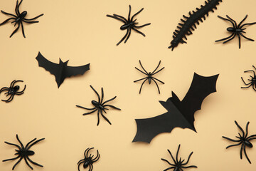 Halloween background with spiders as symbols of Halloween on beige background. Happy Halloween concept