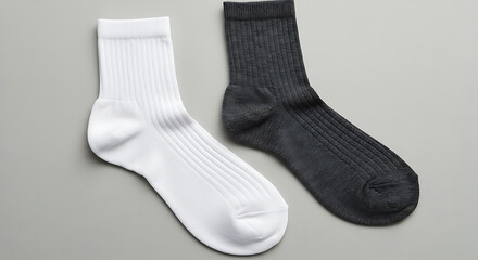 "Stylish crew socks in white and dark gray on backdrop."