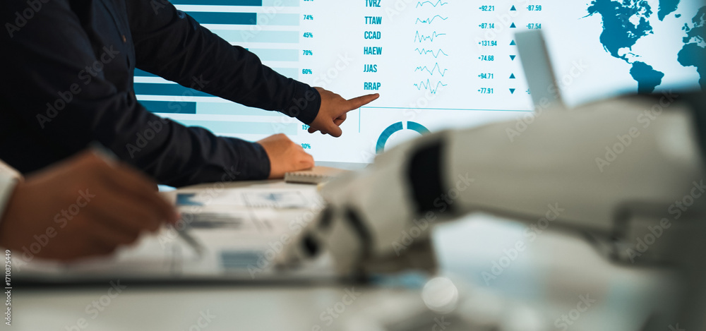 Poster professionals engage in data analysis, utilizing a robotic hand and digital screen to navigate finan