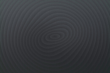Dark concentric circles create a deep, textured ripple effect, evoking a sense of mystery and depth in a monochromatic, abstract pattern