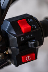 Motorcycle control panel with an emergency engine shutdown and ignition button.