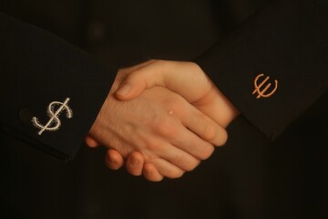 Dollar and Euro hands shaking