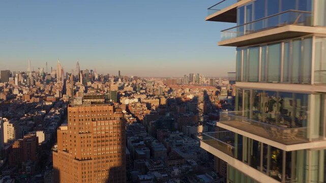 Sunlight gleaming across sleek glass exterior of modern skyscraper in Tribeca, highlighting expansive Manhattan architectural landscape and 60 Hudson Street building