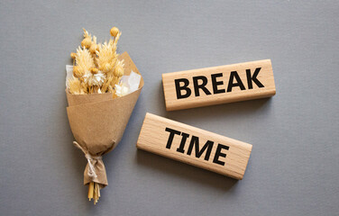 Break Time symbol. Concept word Break Time on wooden blocks. Beautiful grey background with bouquet of flowers. Business and Break Time concept. Copy space