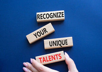 Unique Talents symbol. Concept words Recognize Your Unique Talents on wooden blocks. Beautiful deep blue background. Businessman hand. Business concept. Copy space