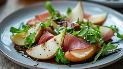 Pear and prosciutto salad with balsamic glaze.