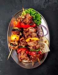 Grilled Kebab Skewers with Meat and Vegetables Isolated on Dark Background for Middle Eastern Food Object and Traditional Cuisine Concept