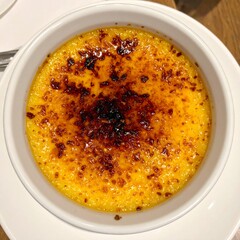 French Crème Brûlée with Caramelized Sugar Top Served in Ceramic Bowl for Premium Dessert Object and Luxury Food Concept