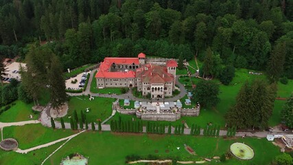 Footage above the territory of famous Cantacuzino Castle in Busteni, Romania. Beautiful landmark surrounded by the lush greenery.