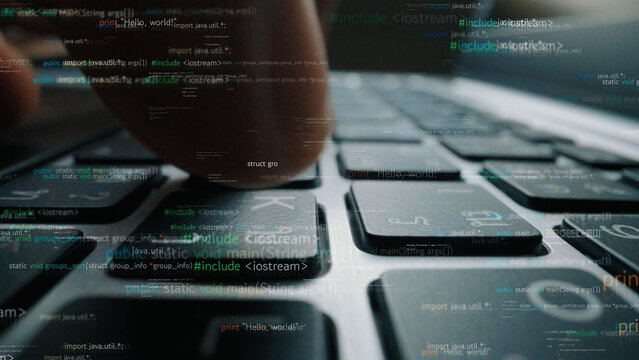 A close-up perspective showing a finger pressing a key on a computer keyboard, surrounded by floating lines of code, symbolizing programming and digital innovation. Xenic