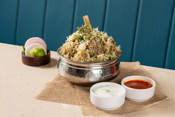 Traditional White Mutton Pulao in a Pot with Accompaniments like Raita and Saalan