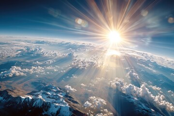 Sunrise above Earth casting dramatic rays over mountains and atmosphere seen from space ideal for inspirational, science and climate themes