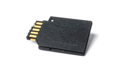 A close-up view of a black memory card with gold contacts, positioned angled on a plain white background.
