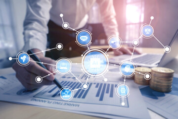 A businessman reviews financial data while utilizing AI technology and digital connections, illustrating modern market trends in a contemporary office setting. Tessel