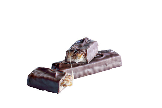 Two candy bars made of peanuts and caramel over a layer of nougat