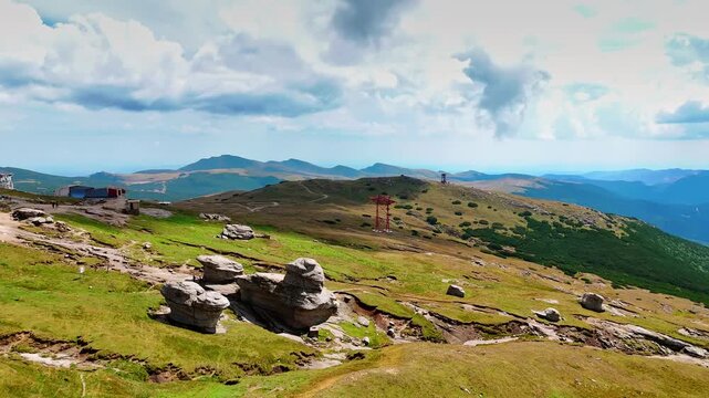Green hills and rocky ridges of Caraiman Plateau. Rolling green hills and rocky ridges stretch across the plateau in Bucegi Mountains.