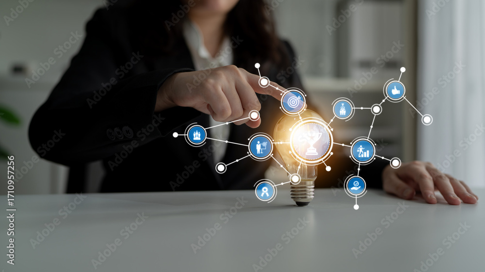 Poster A business professional interacts with a digital interface representing innovation and connectivity. The light bulb symbolizes ideas and creative solutions in work environments. Tessel