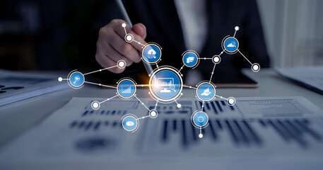 A business professional actively analyzes data trends using a digital interface filled with graphics and connection symbols in a contemporary office setting. Tessel