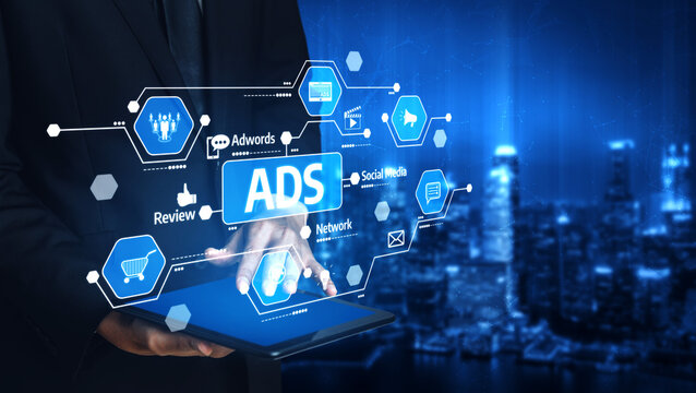 A businessman interacts with a digital tablet displaying various advertising icons and social media symbols, set against a vibrant blue urban background. Tessel