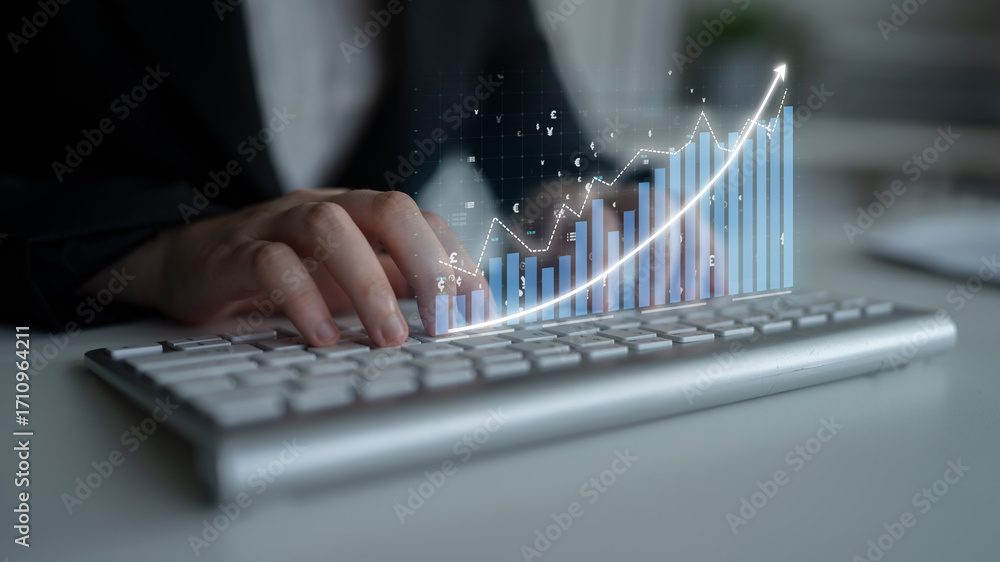 Poster a business professional engages with financial data on a keyboard, showcasing a dynamic graph overla