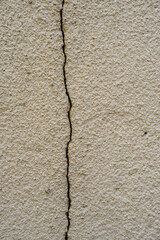 The wall with a crack was plastered over and then cracked again.