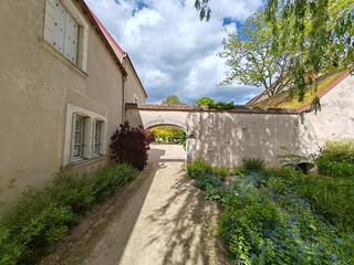 Rustic stone house with archway and garden path