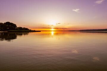 Spectacular sunset over lake Balaton with golden reflections, Hungary.